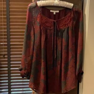Beautiful light airy top.  Size M.  Colors are wine with gray/ black design.